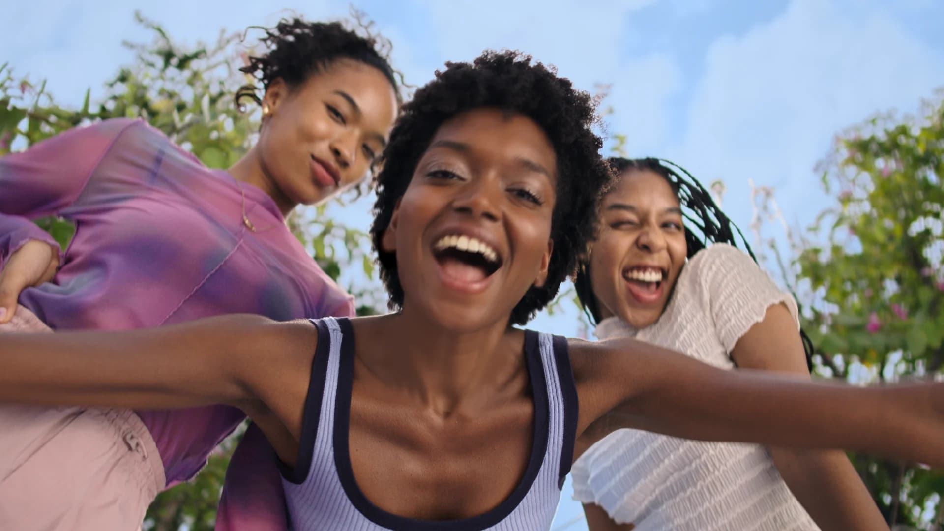 NIVEA campaign frame of three women laughing, with the jewelry removed for a regional version, after